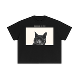 Essential Cotton Boxy T-Shirt in black, front view, printed with a photograph of a cat and the words Checking On You