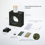 Cuzen Matcha Starter Kit with Matcha Maker, AC adapter, whisking cup, magnetic whisk, and matcha leaves on a white background.