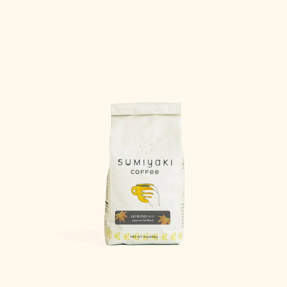 A white bag of Sumiyaki Coffee, Natural Summer Blend, centered on a solid cream-colored background.