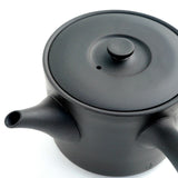 Close-up of the hand-fitted lid and spout of the black Jinsui kyusu